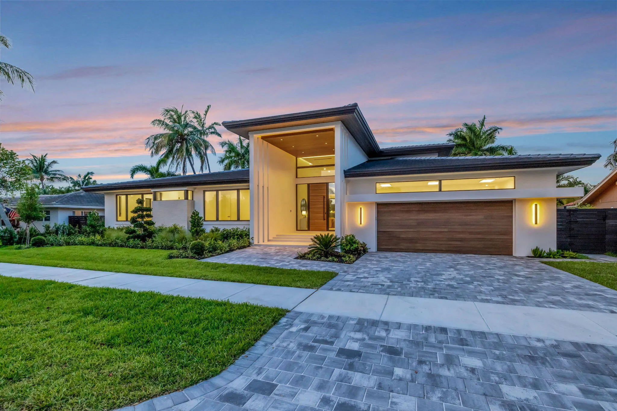 Modern single-story architecture creates strong curb appeal with a refined entry sequence and manicured Fort Lauderdale setting.