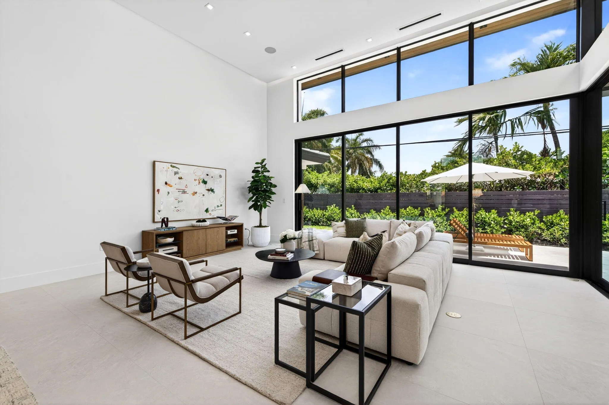 An open interior perspective captures the home's airy scale, refined material palette, and effortless single-story living.