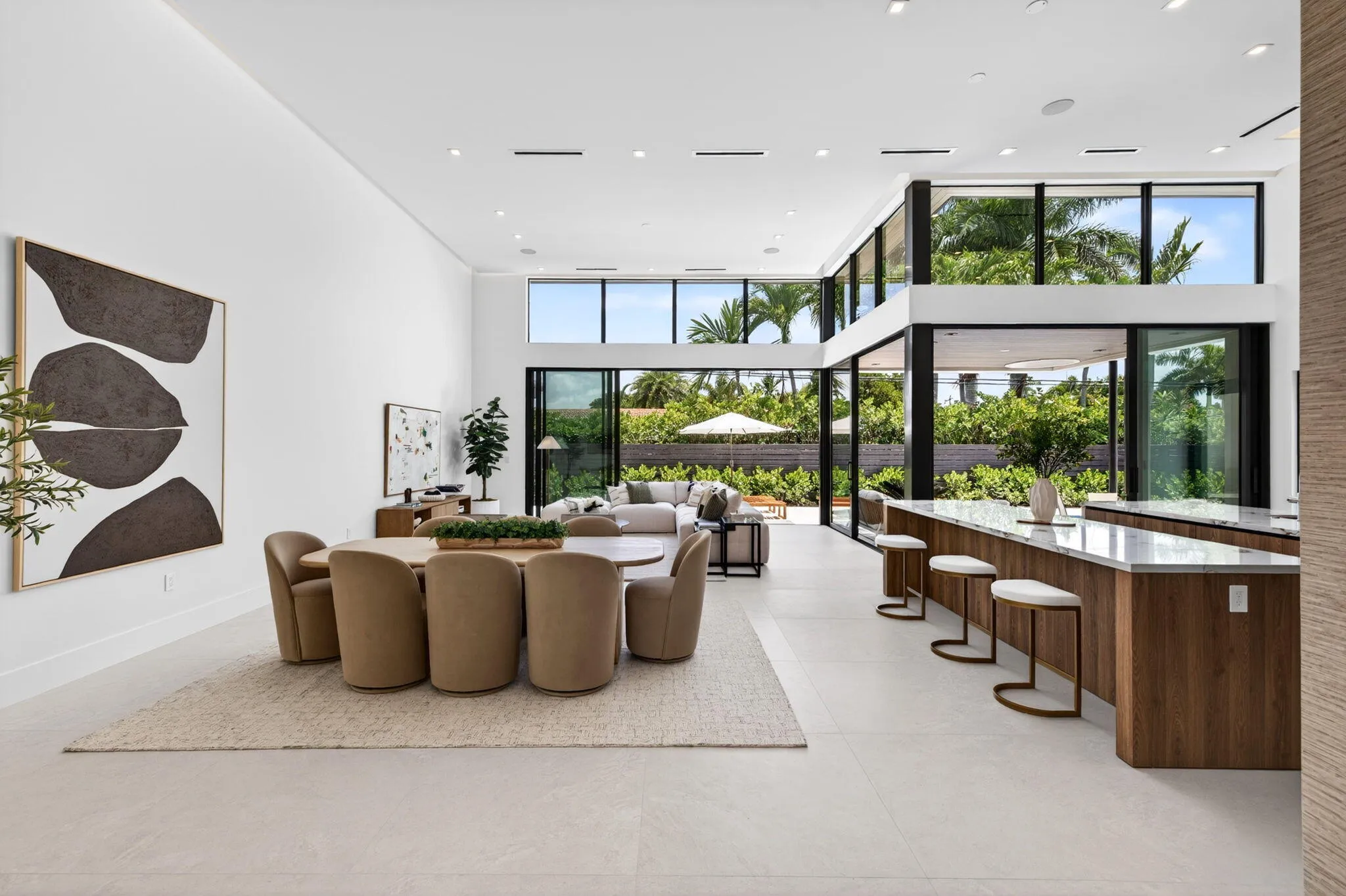 An open interior perspective captures the home's airy scale, refined material palette, and effortless single-story living.