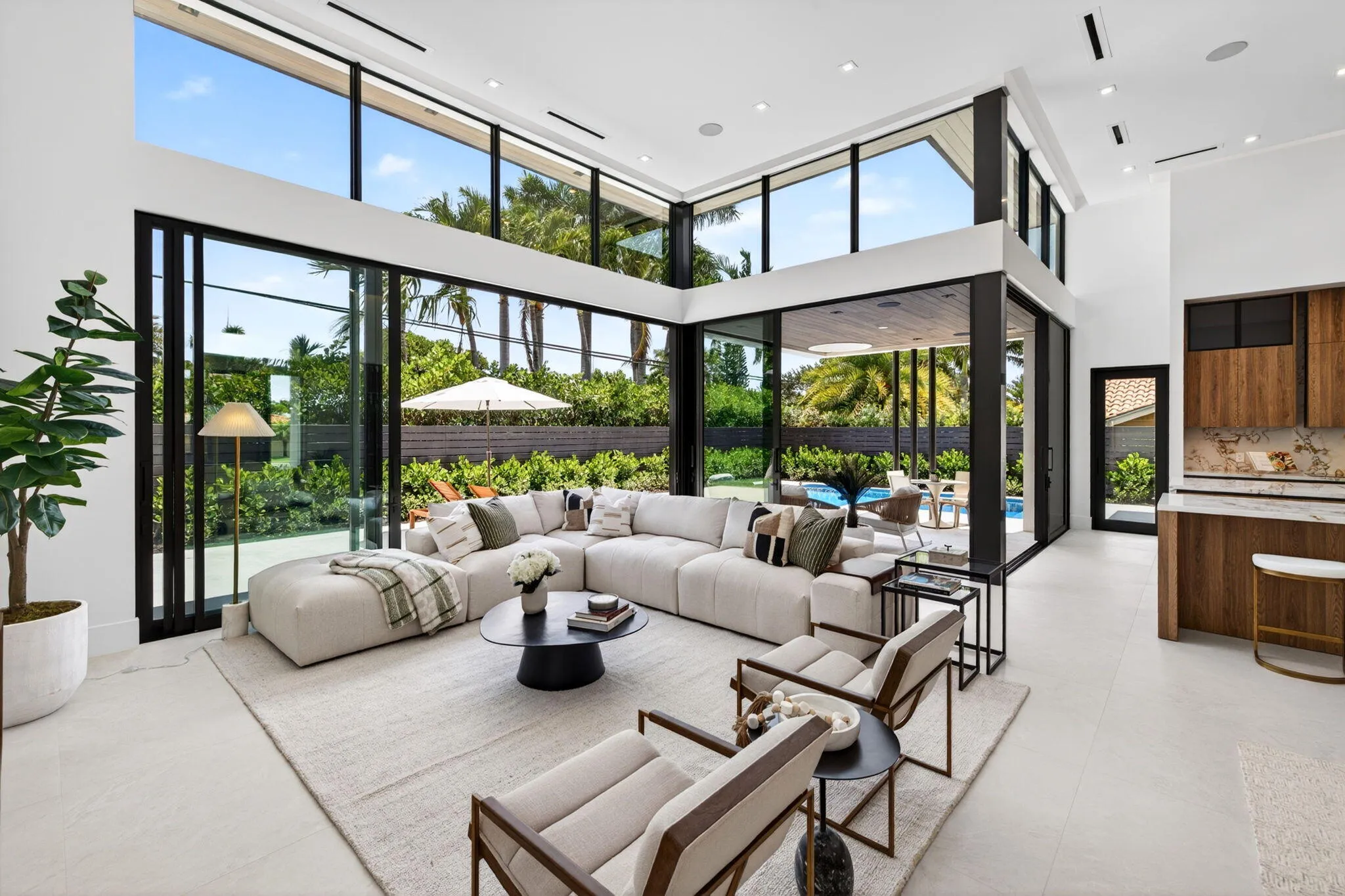 Light-filled interiors emphasize dramatic volume, clean modern finishes, and a seamless connection between living and entertaining spaces.