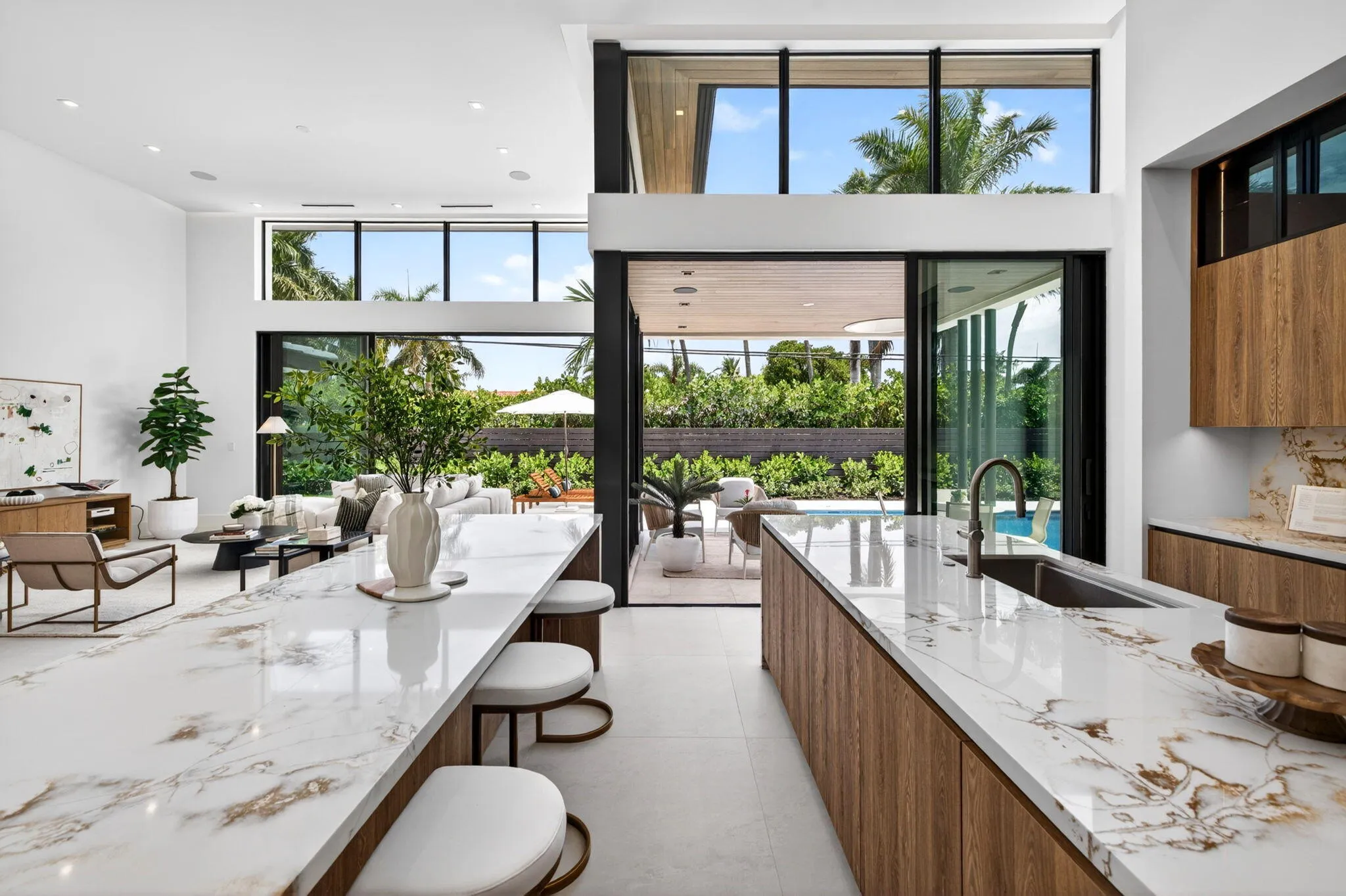 An open interior perspective captures the home's airy scale, refined material palette, and effortless single-story living.