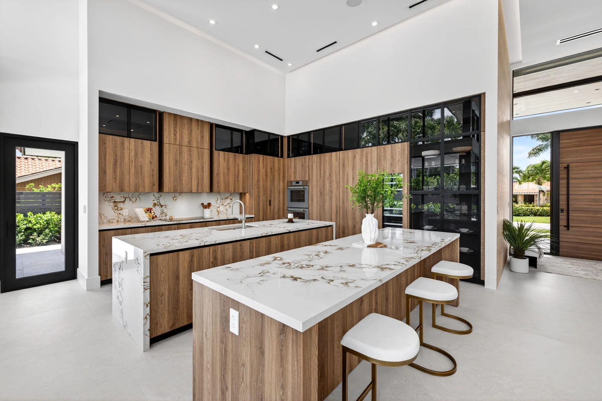 The kitchen combines sculptural design and daily function with premium appliances, custom storage, and polished modern finishes.