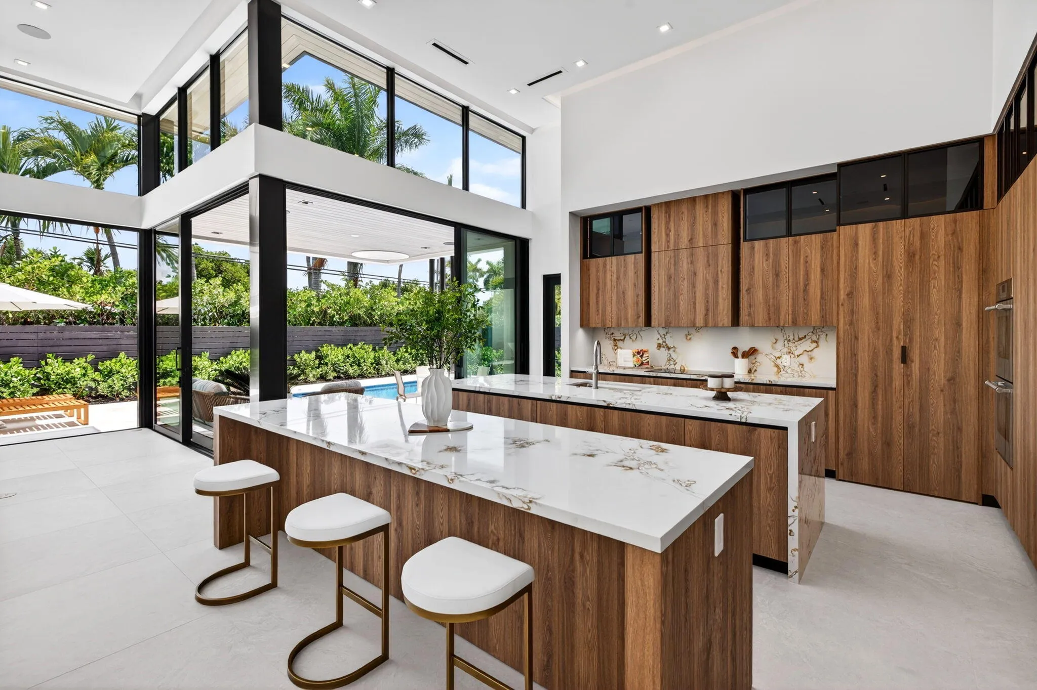Light-filled interiors emphasize dramatic volume, clean modern finishes, and a seamless connection between living and entertaining spaces.