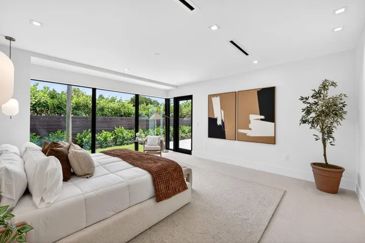 The primary suite offers a serene retreat with garden views, soft natural light, and a calm luxury sensibility.