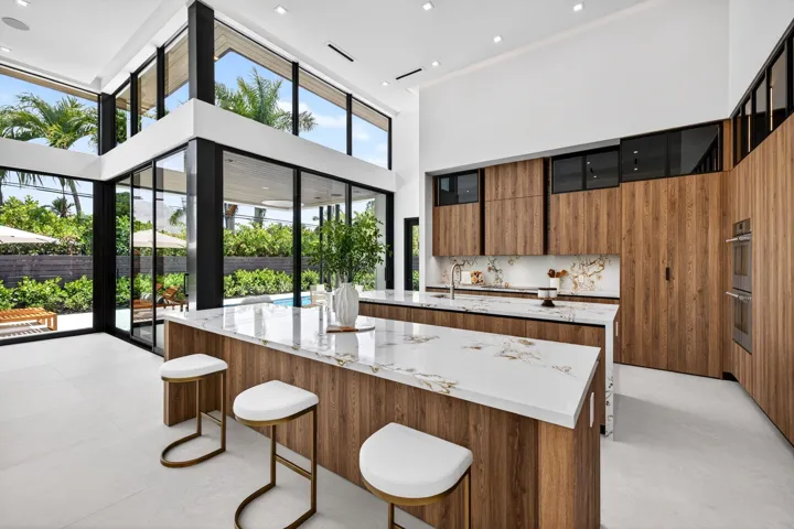 The kitchen combines sculptural design and daily function with premium appliances, custom storage, and polished modern finishes.