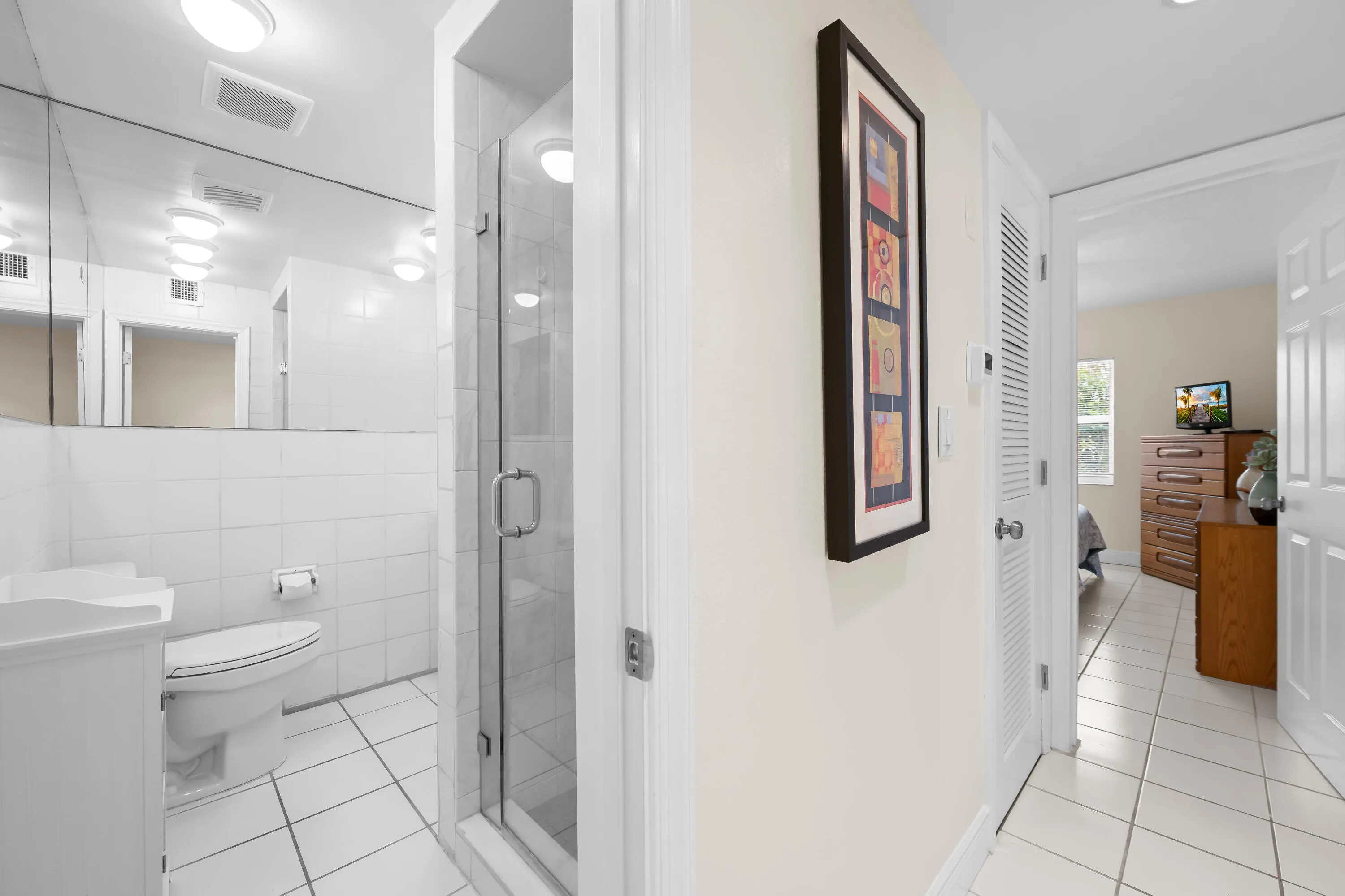 Hallway with bathroom and bedroom view