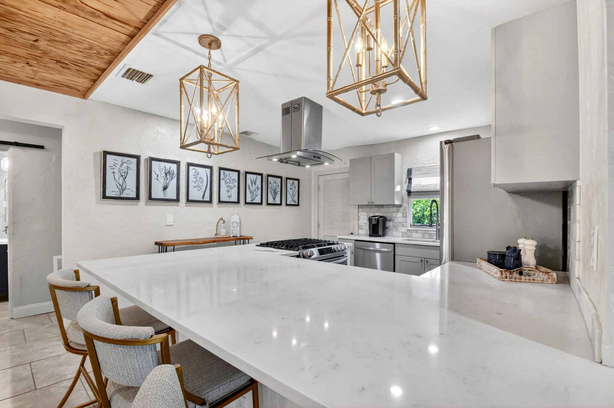 Beautifully updated kitchen quartz counters, shaker cabinets, gas stove and modern appliances.