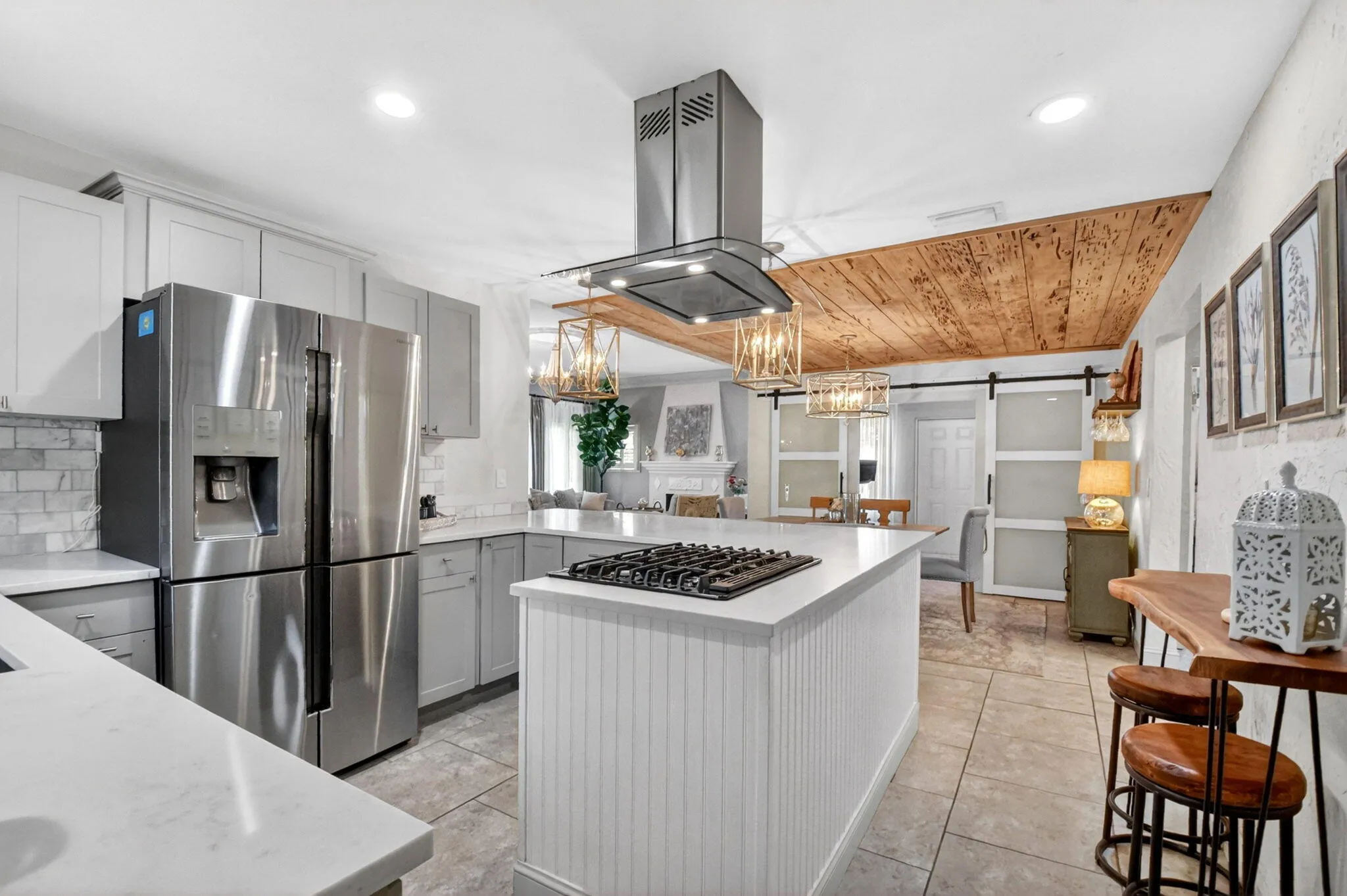 Beautifully updated kitchen quartz counters, shaker cabinets, gas stove and modern appliances.