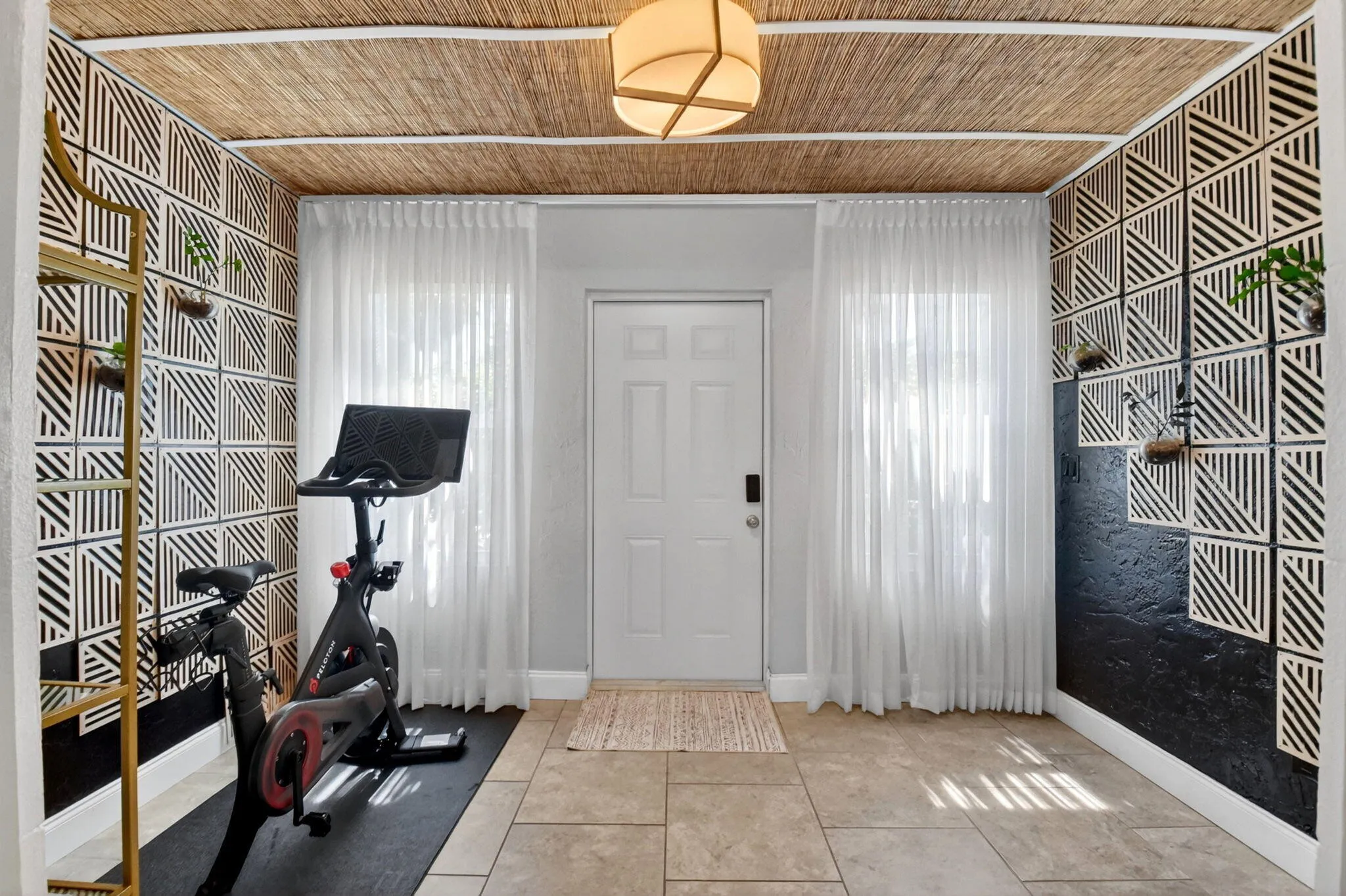 Side entrance with spare room, currently used as a fitness studio.