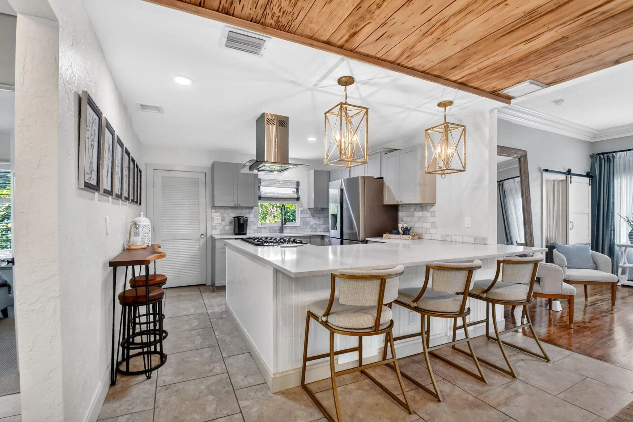 Beautifully updated kitchen quartz counters, shaker cabinets, gas stove and modern appliances.