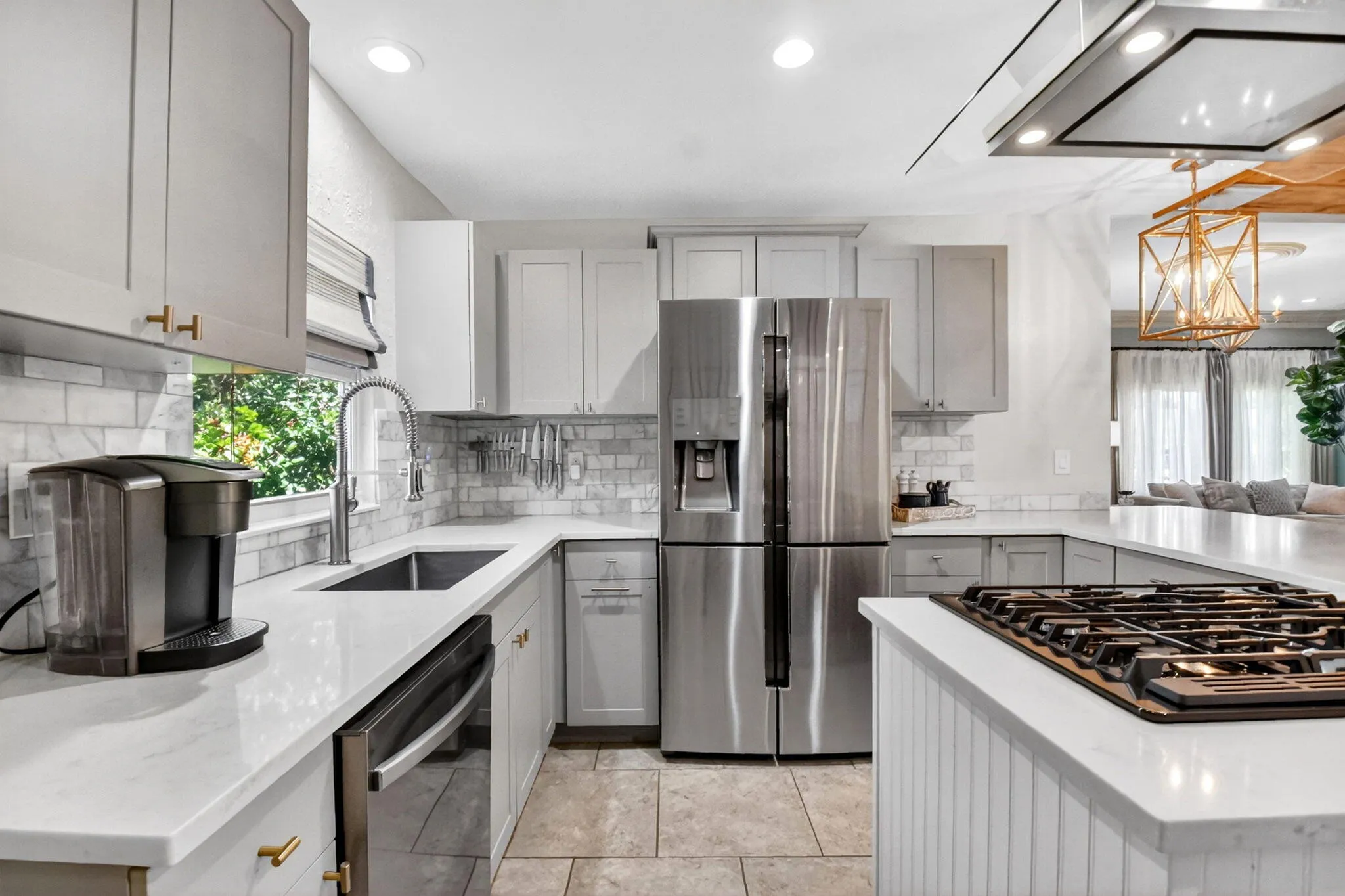 Beautifully updated kitchen quartz counters, shaker cabinets, gas stove and modern appliances.