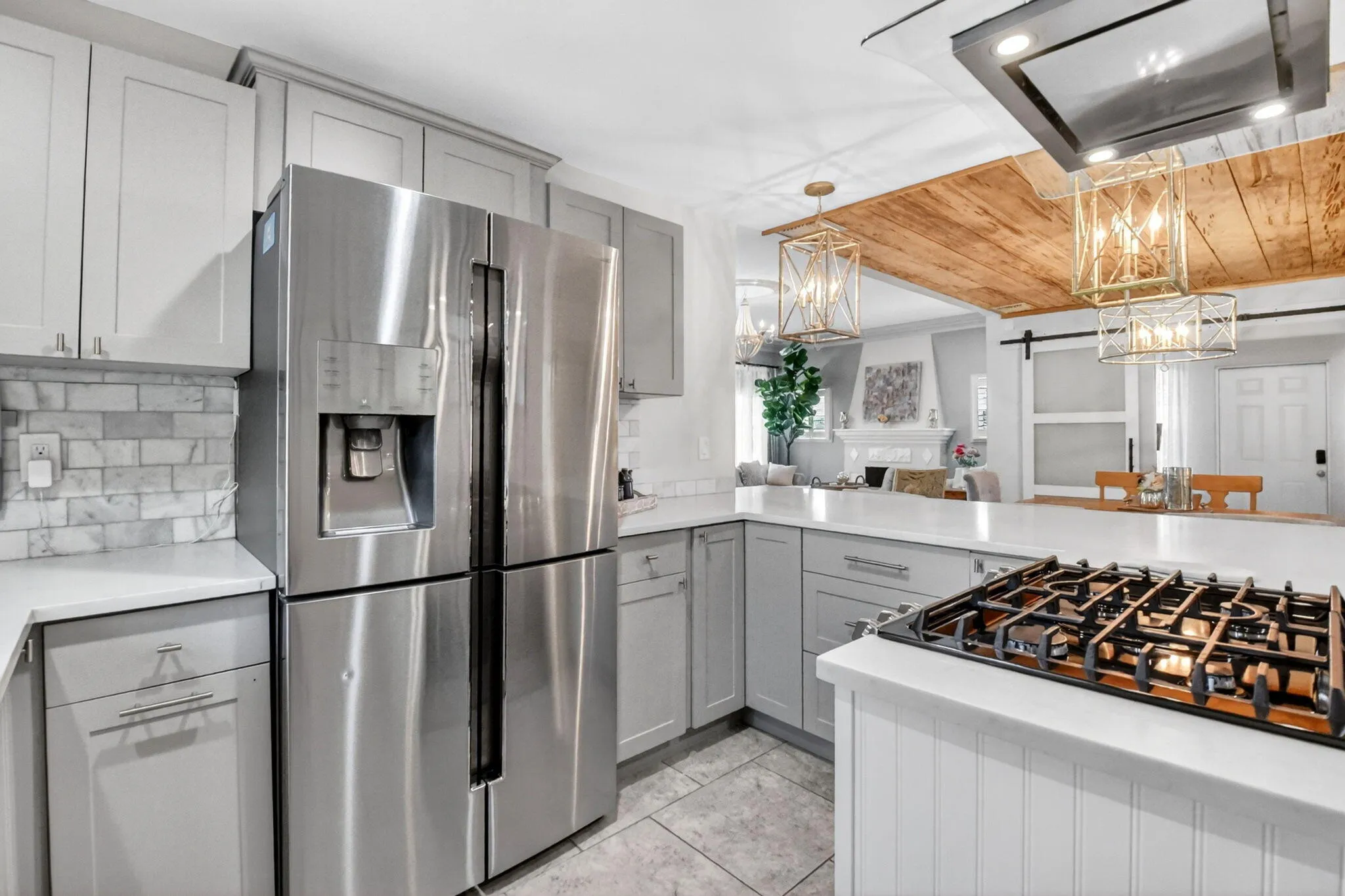 Beautifully updated kitchen quartz counters, shaker cabinets, gas stove and modern appliances.