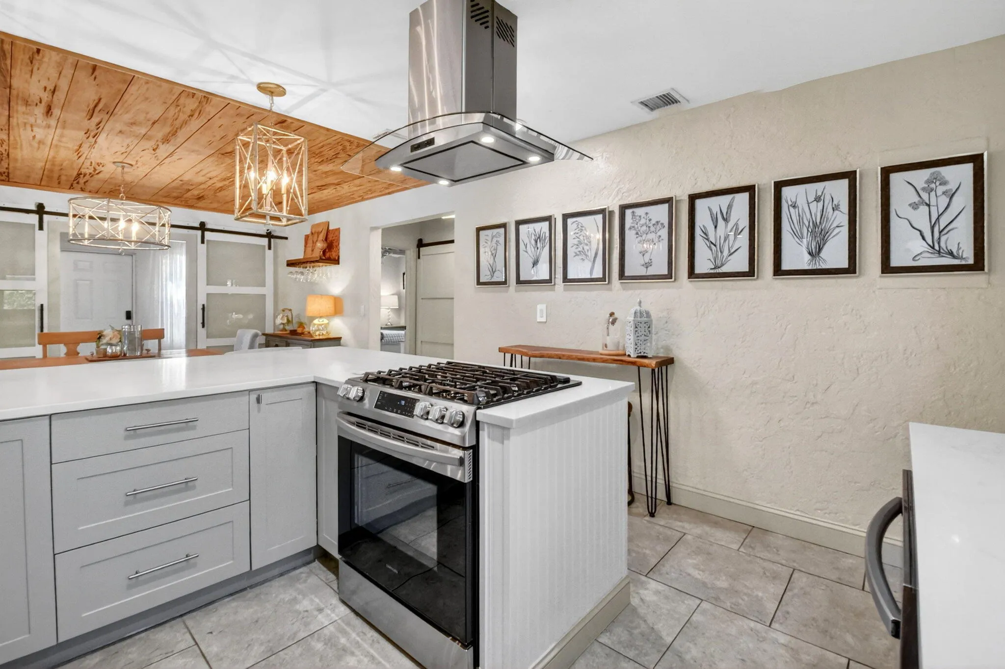 Beautifully updated kitchen quartz counters, shaker cabinets, gas stove and modern appliances.