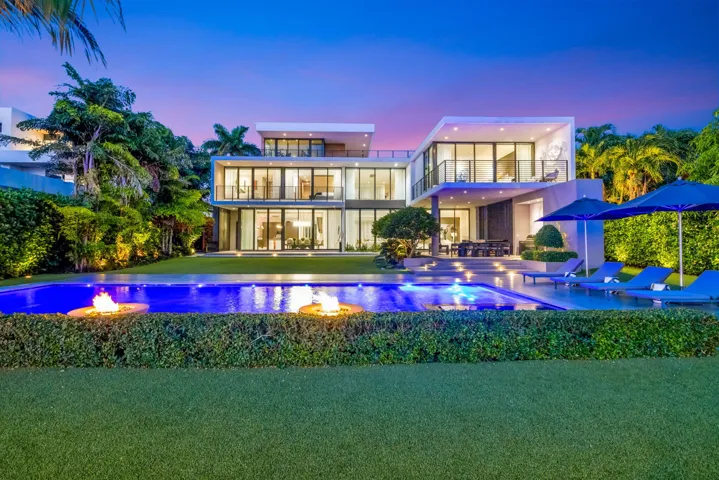 A resort-inspired waterfront setting showcasing the 50-foot saltwater pool, manicured grounds, and striking contemporary rear elevation along the Middle River.