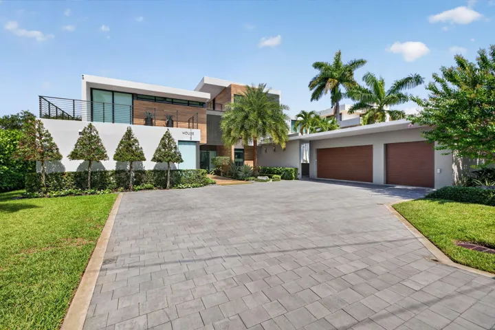 A memorable arrival experience defined by contemporary architecture, tropical landscaping, gated privacy, and an impressive motor court.