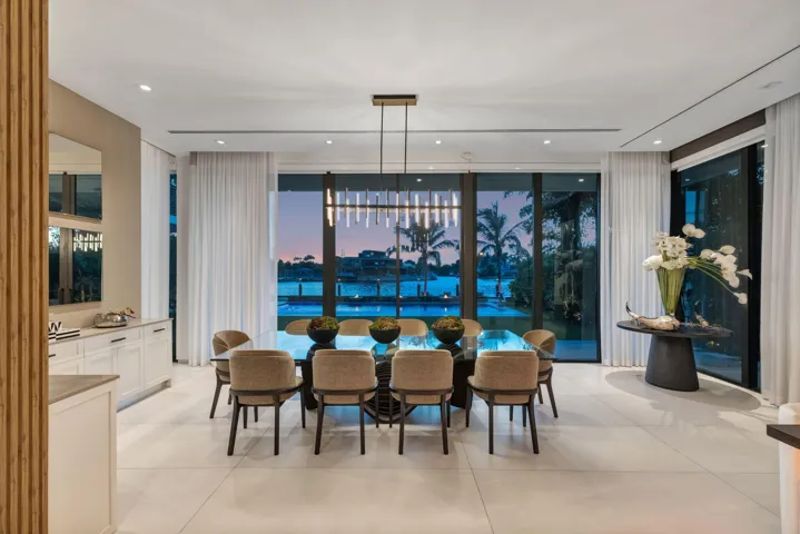 A sophisticated dining setting wrapped in natural light and river views, creating an elegant backdrop for intimate dinners and memorable entertaining.