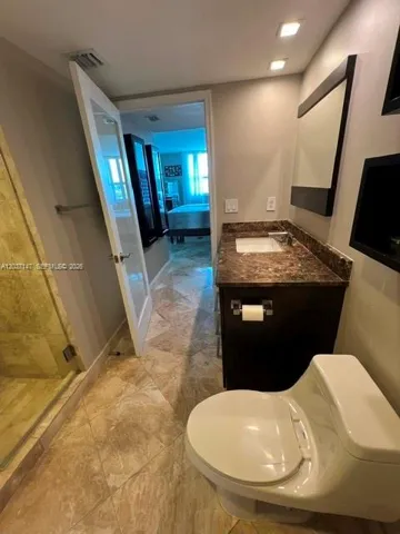 View from master bathroom through the powder sink to master bedroom