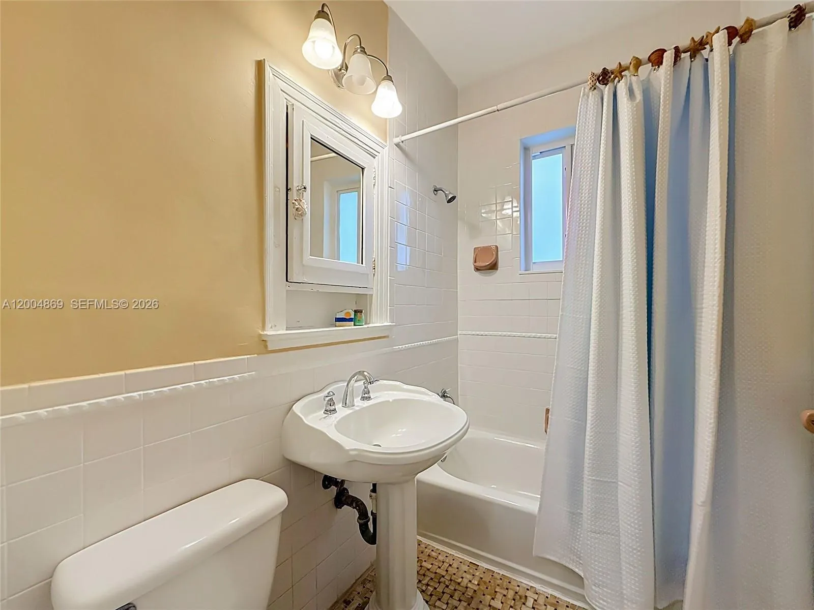 One of three full bathrooms - this one with combined tub/shower