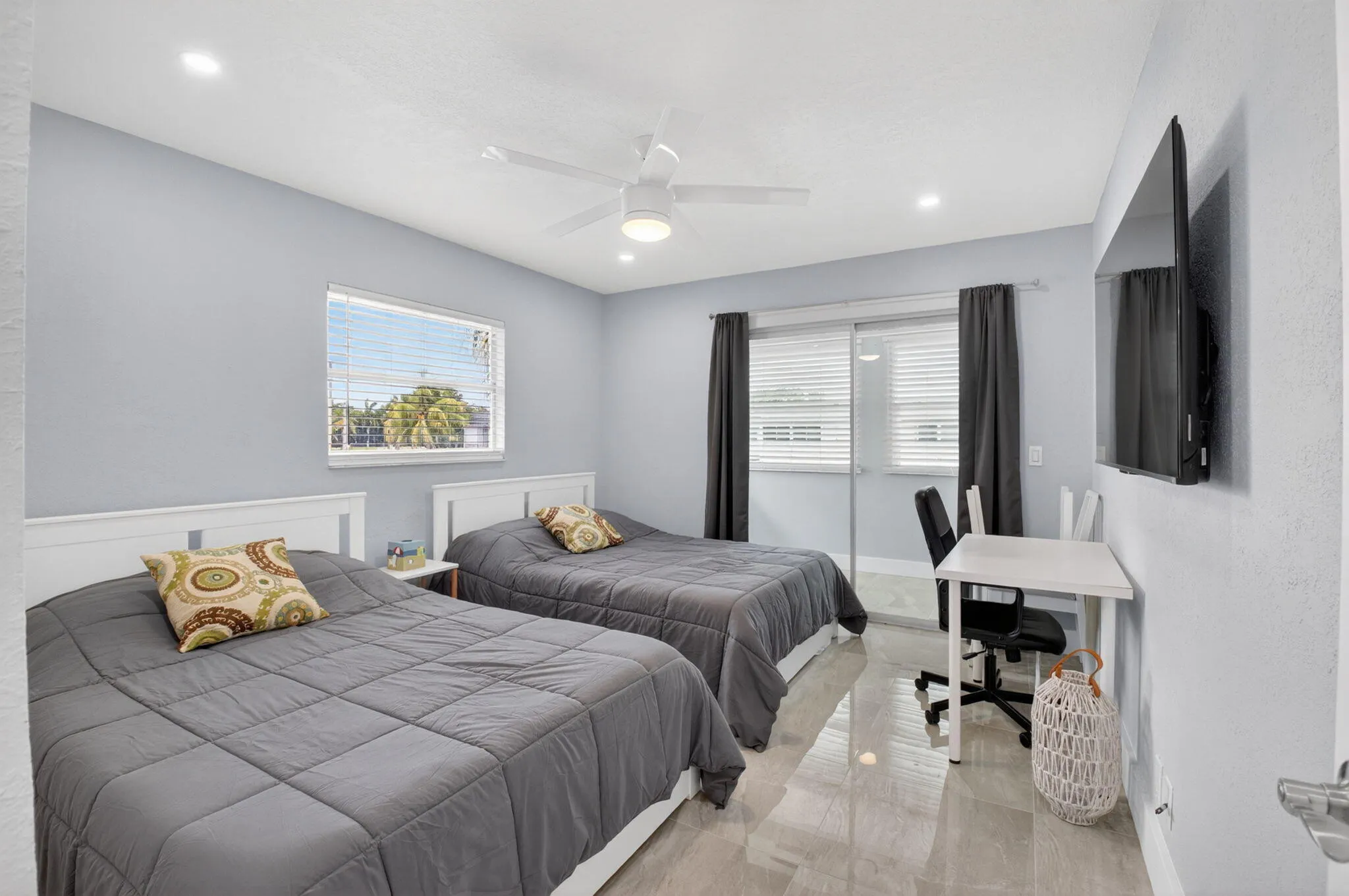 Second bedroom with patio entrance! (One of the beds will be replaced with a Queen bed).