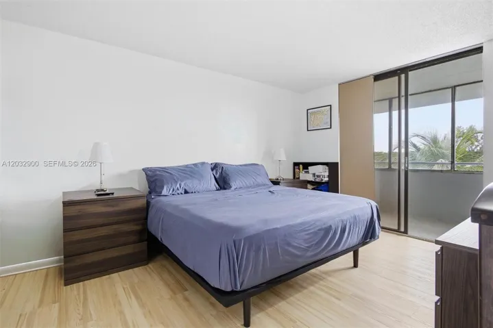 Primary Bedroom with balcony and lake view