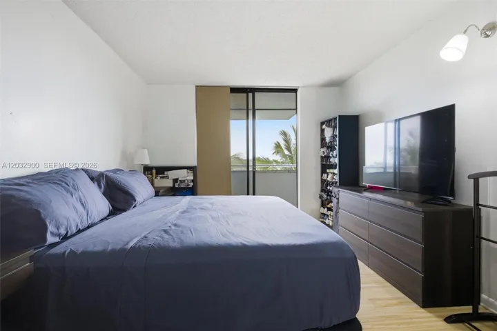 Primary Bedroom with balcony and lake view