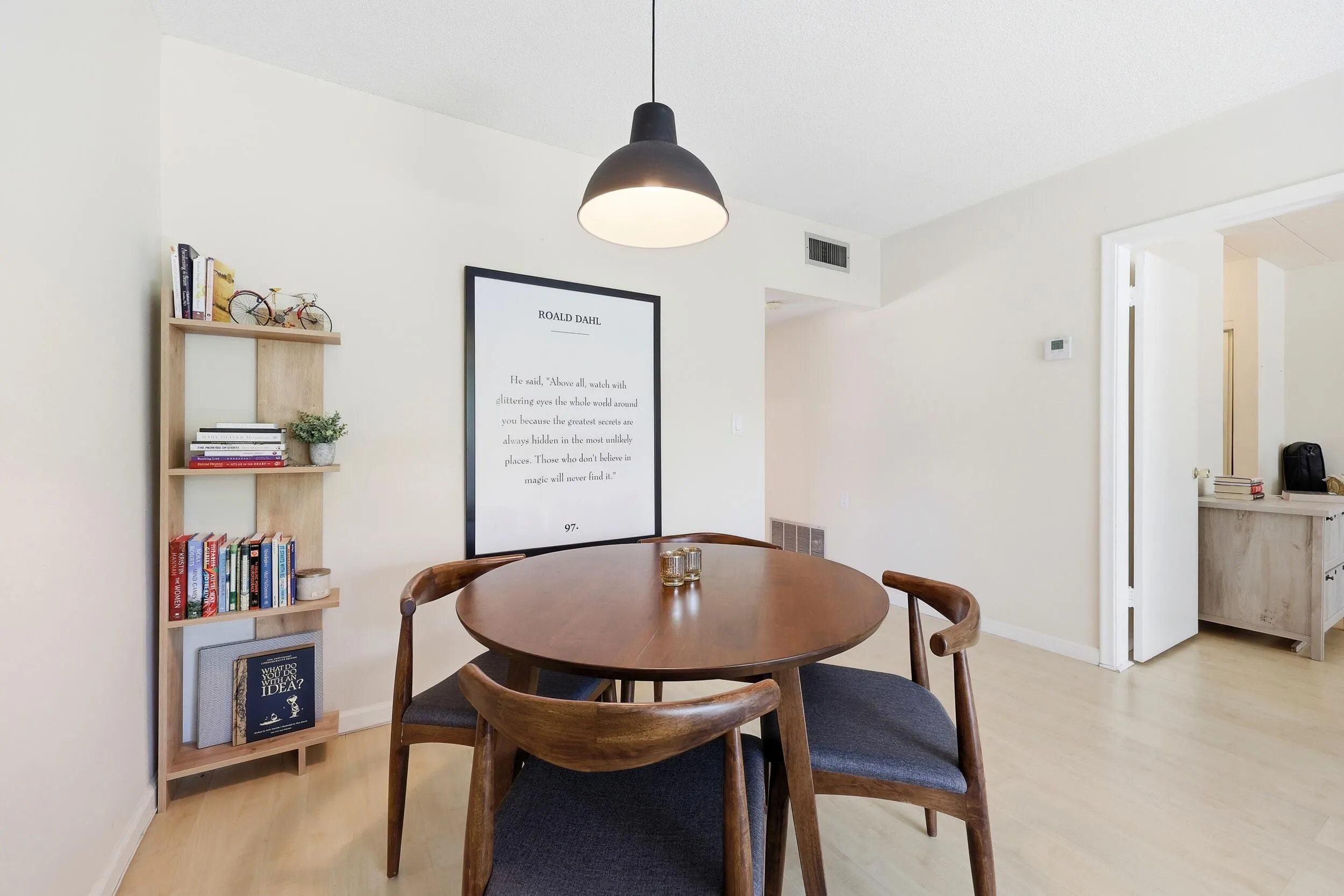 The dining area is seamlessly integrated into the main living space, creating an open and inviting environment for everyday meals and entertaining. Generous proportions easily accommodate a full dining set, while the central location between the living room and kitchen enhances both functionality and flow. The modern pendant lighting adds warmth and character, and the open-concept design allows the space to feel bright, connected, and welcoming for gatherings of any size.
