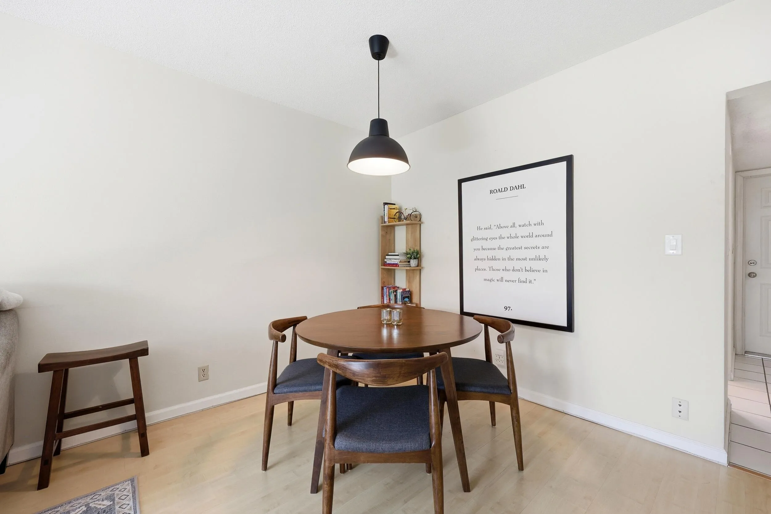 The dining area is seamlessly integrated into the main living space, creating an open and inviting environment for everyday meals and entertaining. Generous proportions easily accommodate a full dining set, while the central location between the living room and kitchen enhances both functionality and flow. The modern pendant lighting adds warmth and character, and the open-concept design allows the space to feel bright, connected, and welcoming for gatherings of any size.