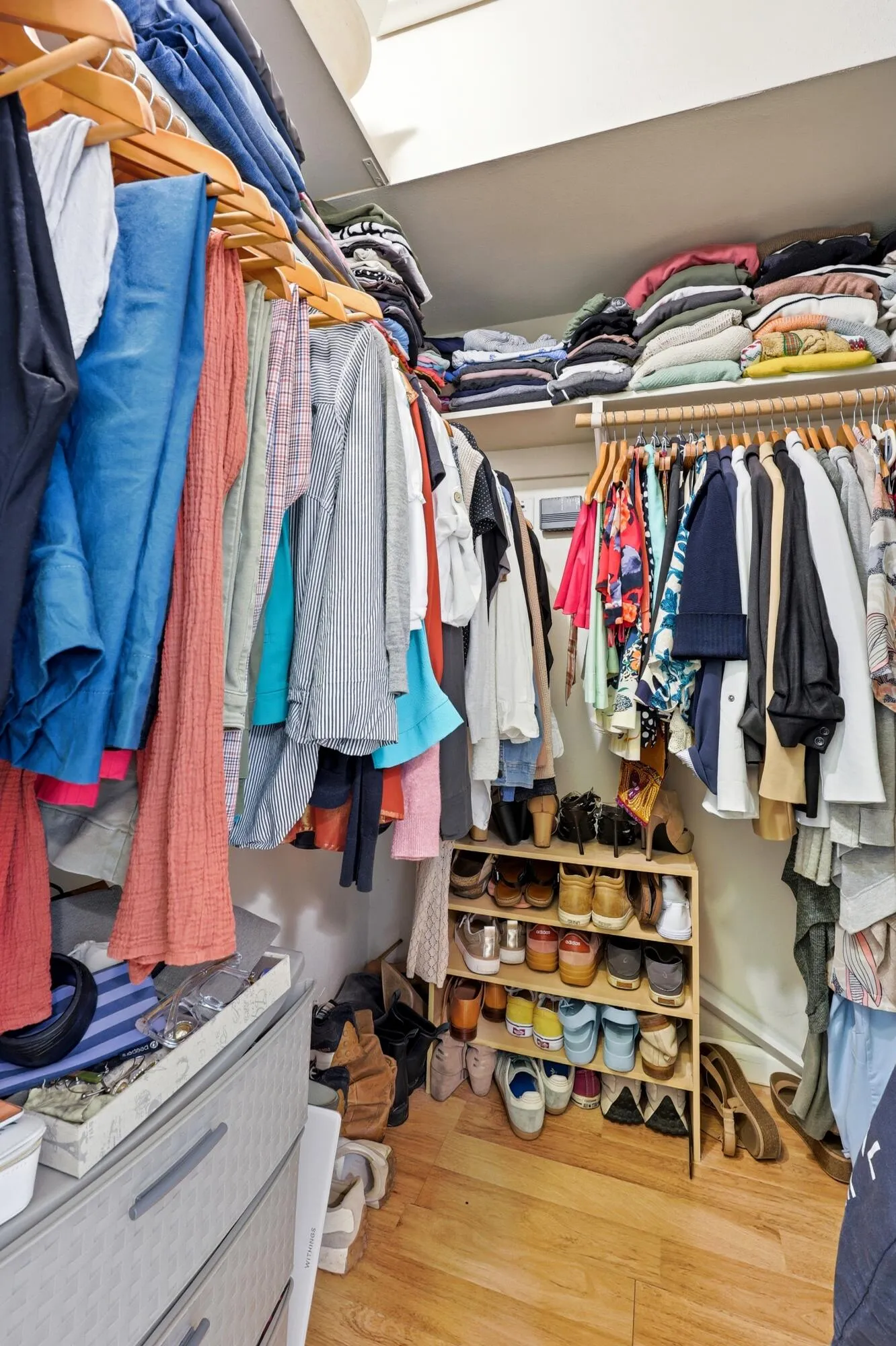 The spacious walk-in closet offers an impressive amount of storage with multiple hanging areas, built-in shelving, and ample room for shoes, accessories, and seasonal items. Designed to maximize organization and functionality, this generous closet provides the storage space often sought after but rarely found in a one-bedroom condominium.