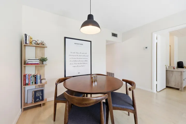 The dining area is seamlessly integrated into the main living space, creating an open and inviting environment for everyday meals and entertaining. Generous proportions easily accommodate a full dining set, while the central location between the living room and kitchen enhances both functionality and flow. The modern pendant lighting adds warmth and character, and the open-concept design allows the space to feel bright, connected, and welcoming for gatherings of any size.