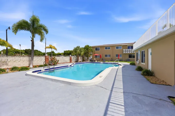The resort-style community pool and sundeck provide the perfect setting to relax and enjoy South Florida's year-round sunshine. Recently renovated in 2025, the pool area features expansive deck space, tropical landscaping, lounge seating, and shaded gathering areas ideal for socializing with neighbors or unwinding after a day at the beach. Surrounded by swaying palm trees and well-maintained grounds, this inviting outdoor amenity creates a peaceful retreat just steps from home. The building was freshly painted in 2024, further enhancing the pride of ownership throughout the community.