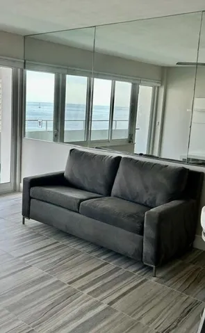 MIRROR ON WEST WALL REFLECTS THE OCEAN