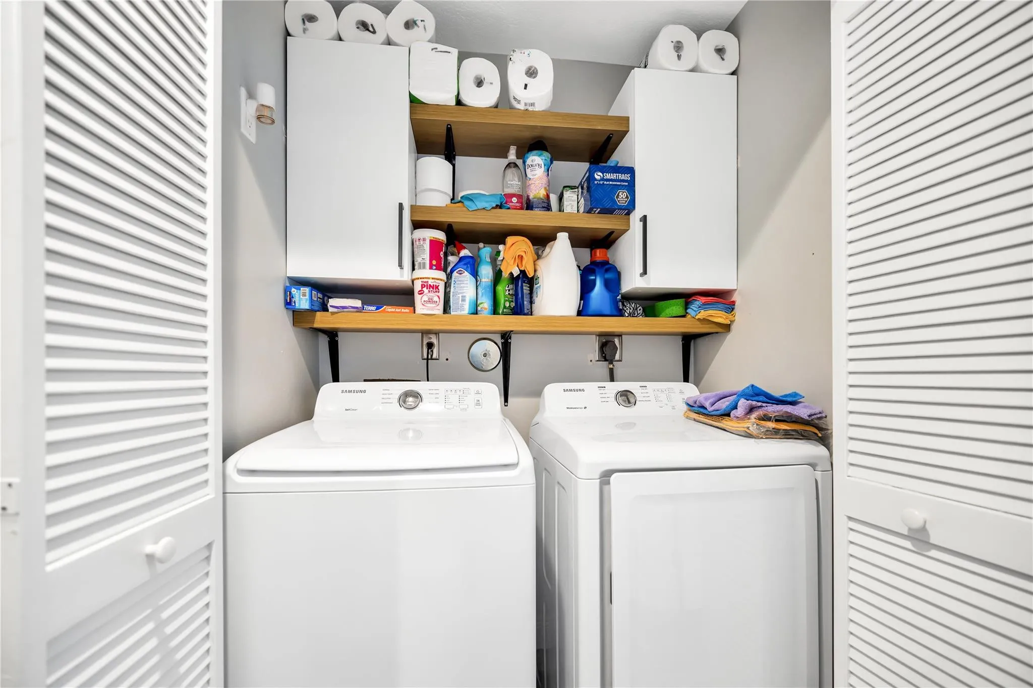 Laundry Closet with shelving and storage.