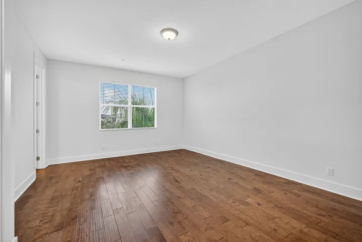 Primary Bedroom with wood flooring