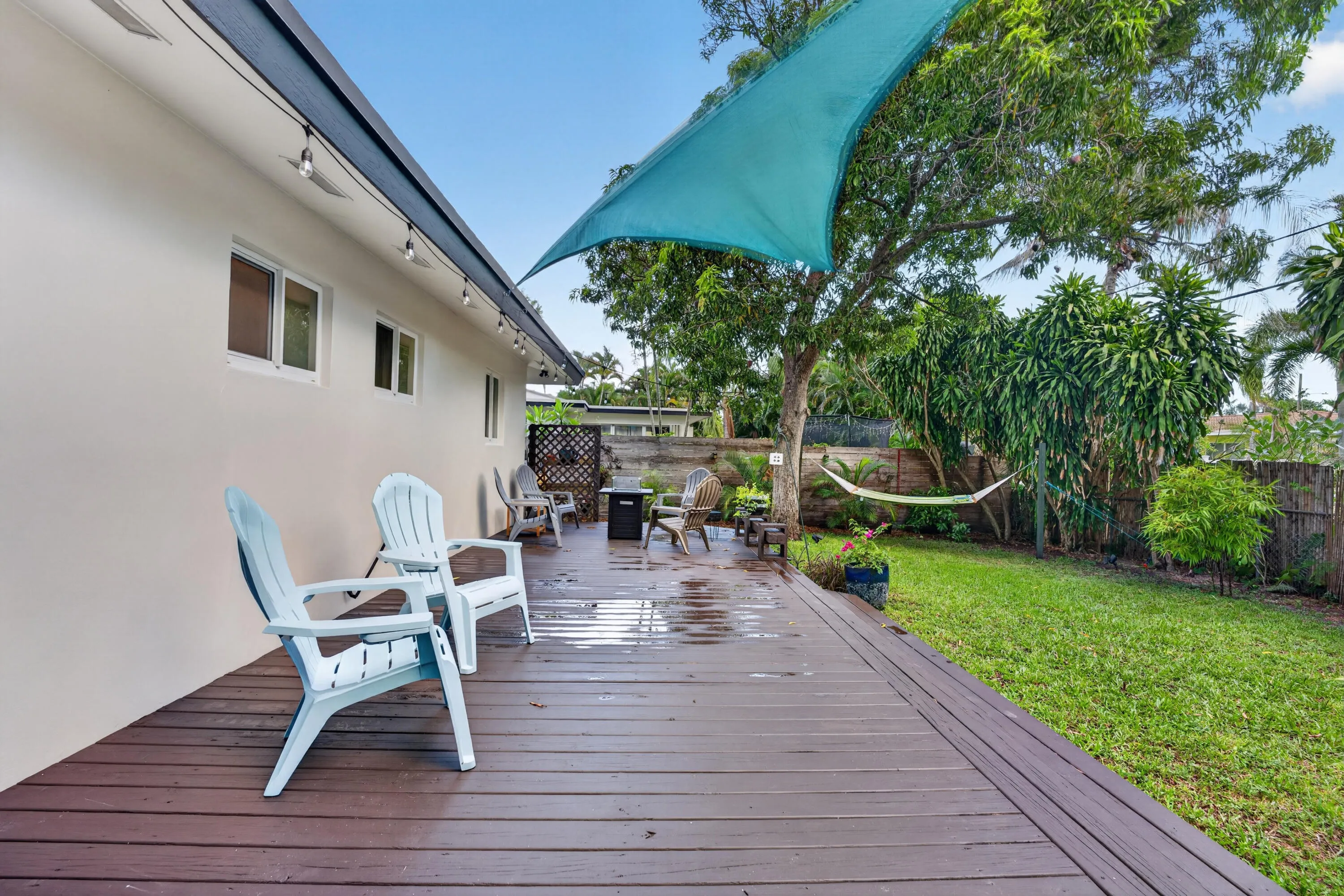 Beautiful wooden deck highlights the back oasis.