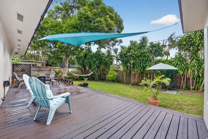 Beautiful wooden deck highlights the back oasis.