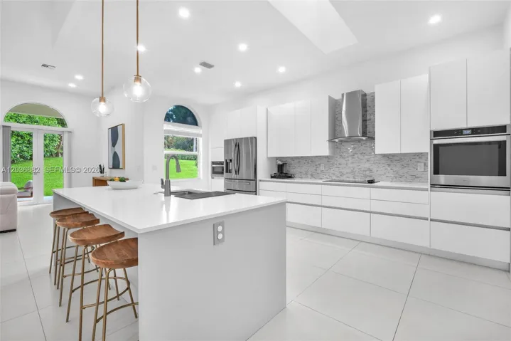 Remodeled kitchen with island and dine in bar stool station