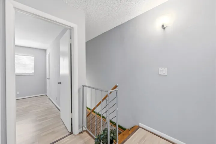 Staircase connecting the main living area to the bedrooms and full bathroom, offering added privacy and a true townhome feel.