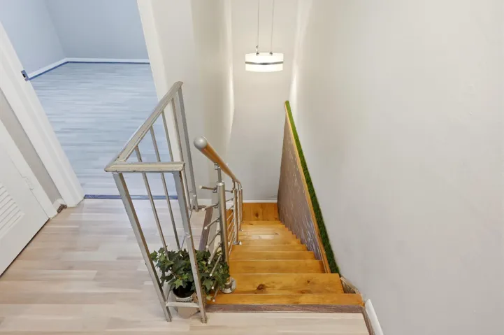 Staircase leading to the bedrooms and full bathroom, creating a well designed separation of living and private spaces.