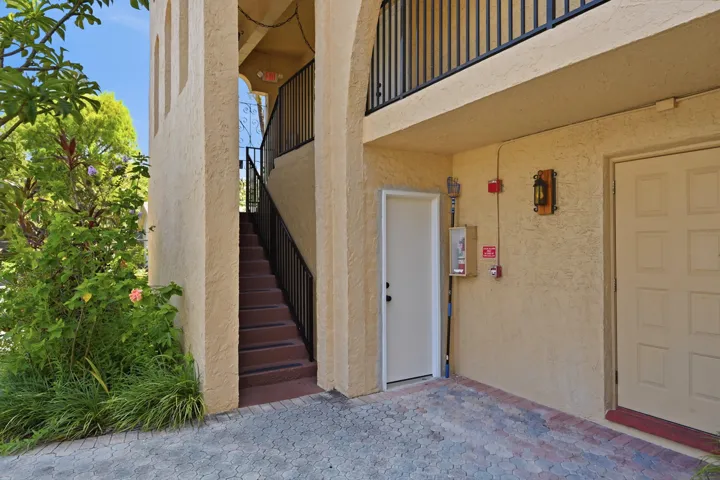 Exterior view highlighting the staircase leading to the home's entrance.