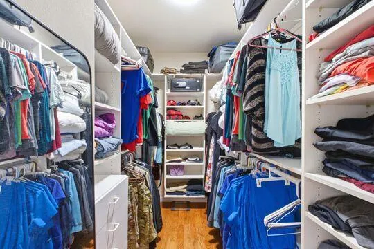 walk in closet with lots of storage and shelving