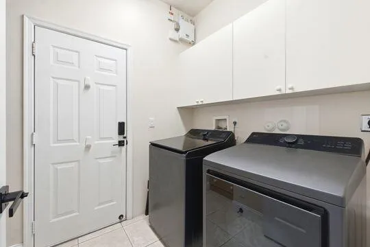 Newer "smart" washer and dryer with lots of cabinets and storage