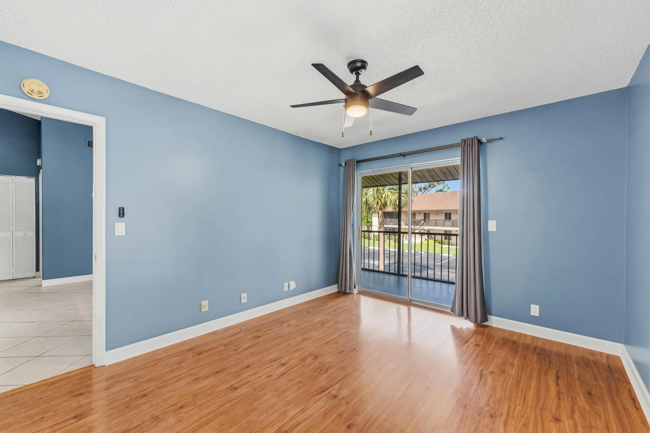 Primary bedroom with slider out to screen balcony