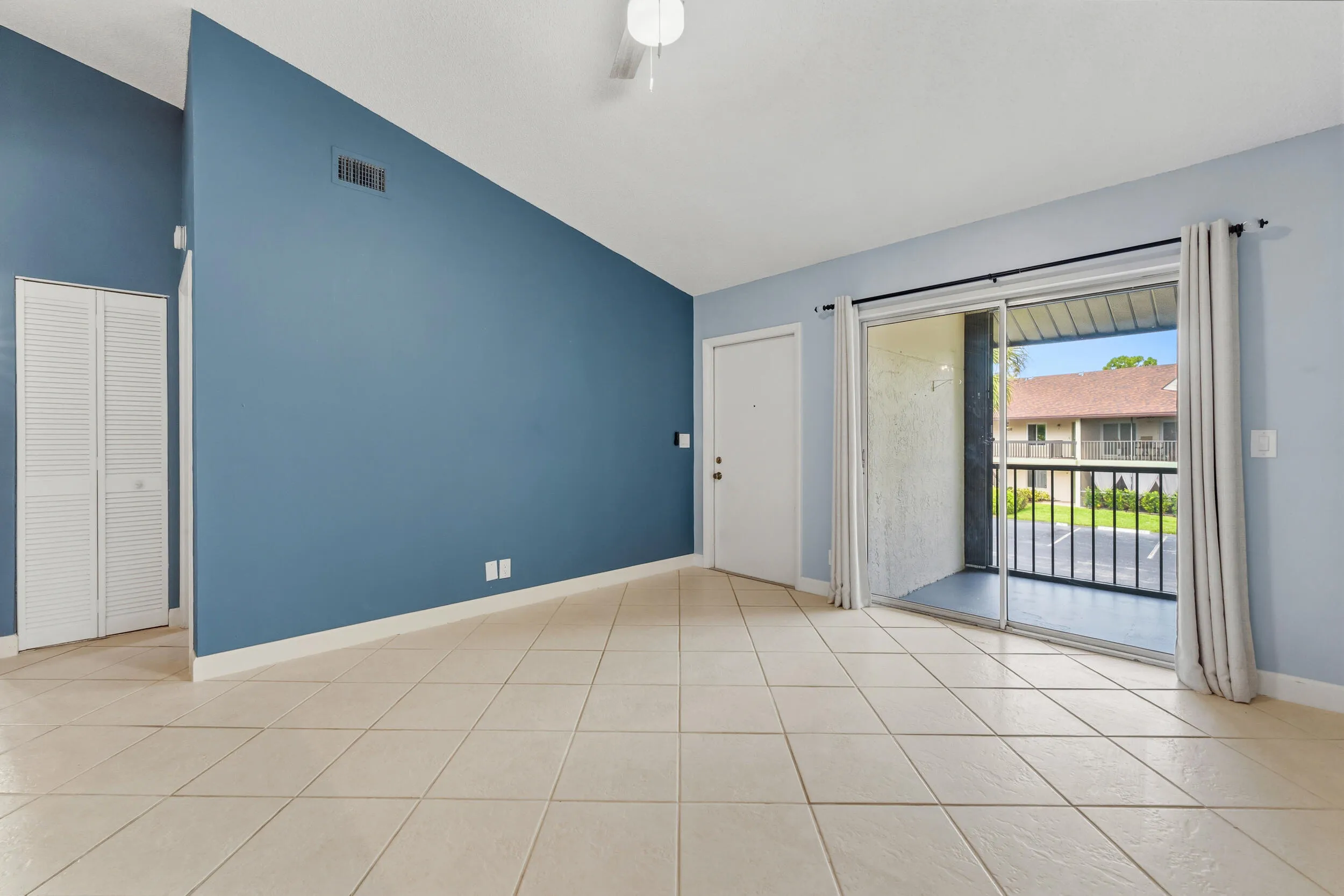 Living area has a slider out to the screen balcony.