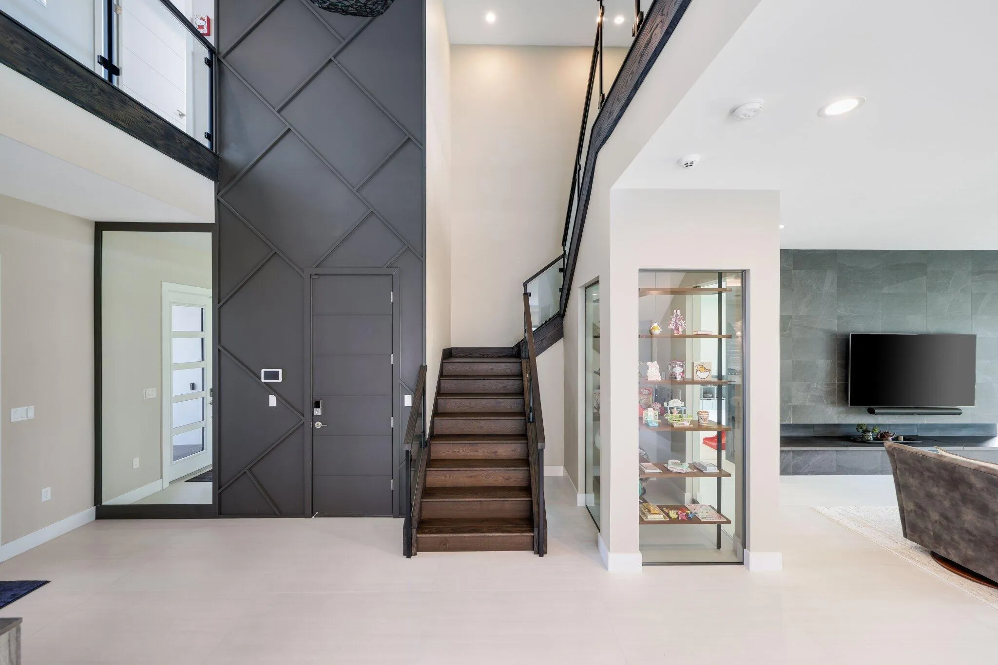 Lutron Automated Lighting throughout the entire house. Glass enclosed display room w shelving. Easy to make into a wine room.