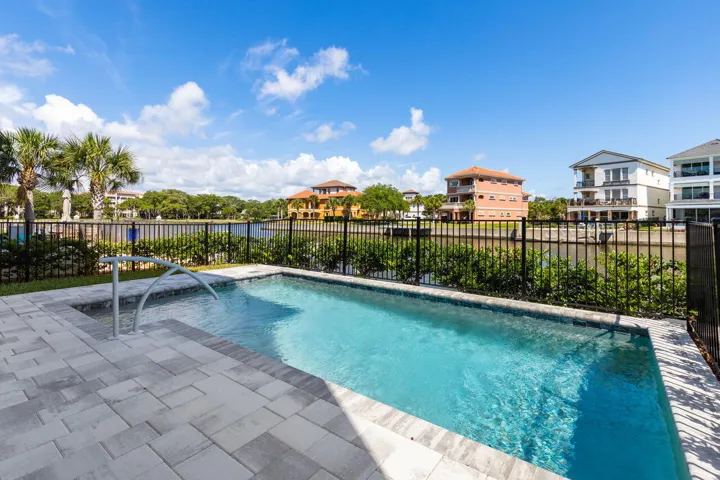 Dive into your private pool with sparkling waterfront views that make every afternoon feel like a permanent vacation.