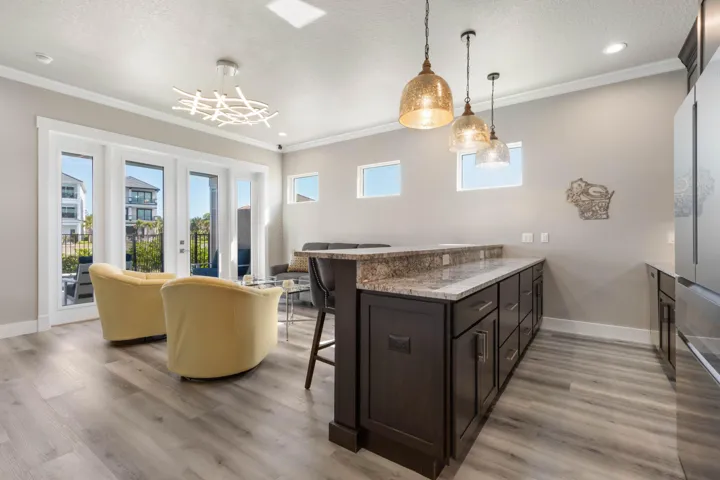 Whether hosting game day, morning coffee, or evening cocktails, this stylish lower-level retreat creates a fun, relaxed atmosphere that instantly feels welcoming and connected.