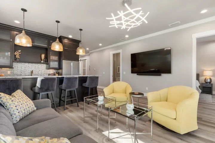 Fun, stylish, and effortlessly inviting, this vibrant entertainment space glows with designer lighting made for cocktail hours, movie nights, and unforgettable gatherings.
