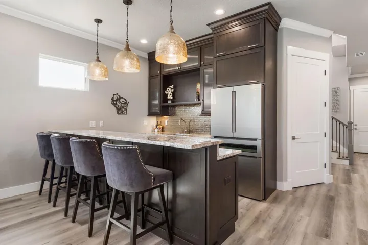 The first-floor kitchen is thoughtfully equipped with a full-size refrigerator and dishwasher, making entertaining feel effortless.