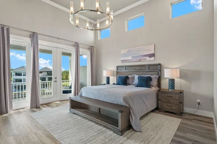 Perched on the third floor, this serene primary suite feels like a private escape where soaring ceilings, soft natural light, and peaceful balcony access create the perfect place to begin and end each day