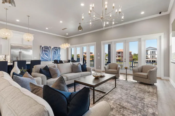 Sophisticated open-concept living spaces blend modern elegance with effortless comfort, creating a stunning backdrop for unforgettable gatherings and relaxed coastal living